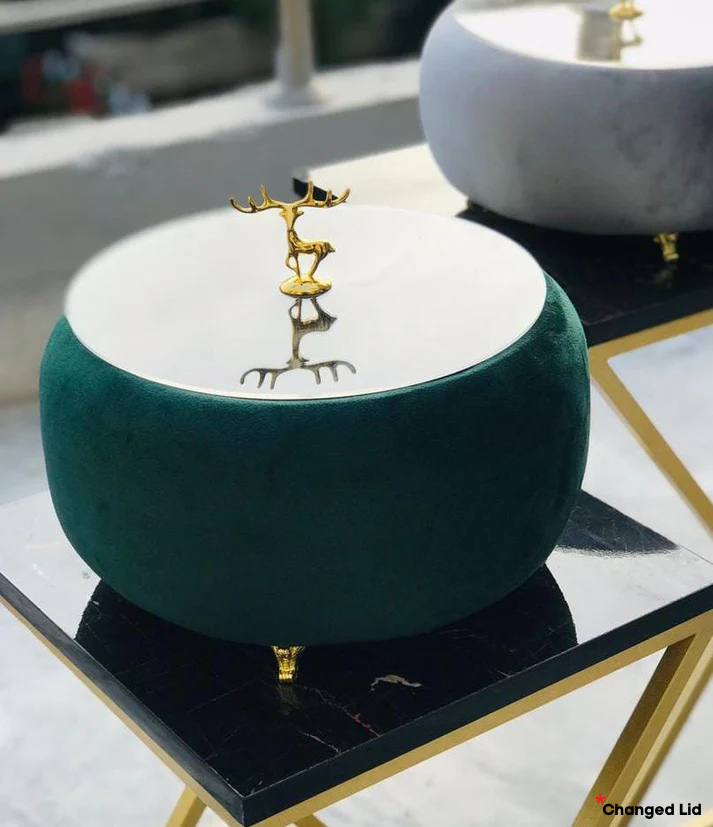 Green Turkish Hotpot with a gold deer figurine on a marble surface