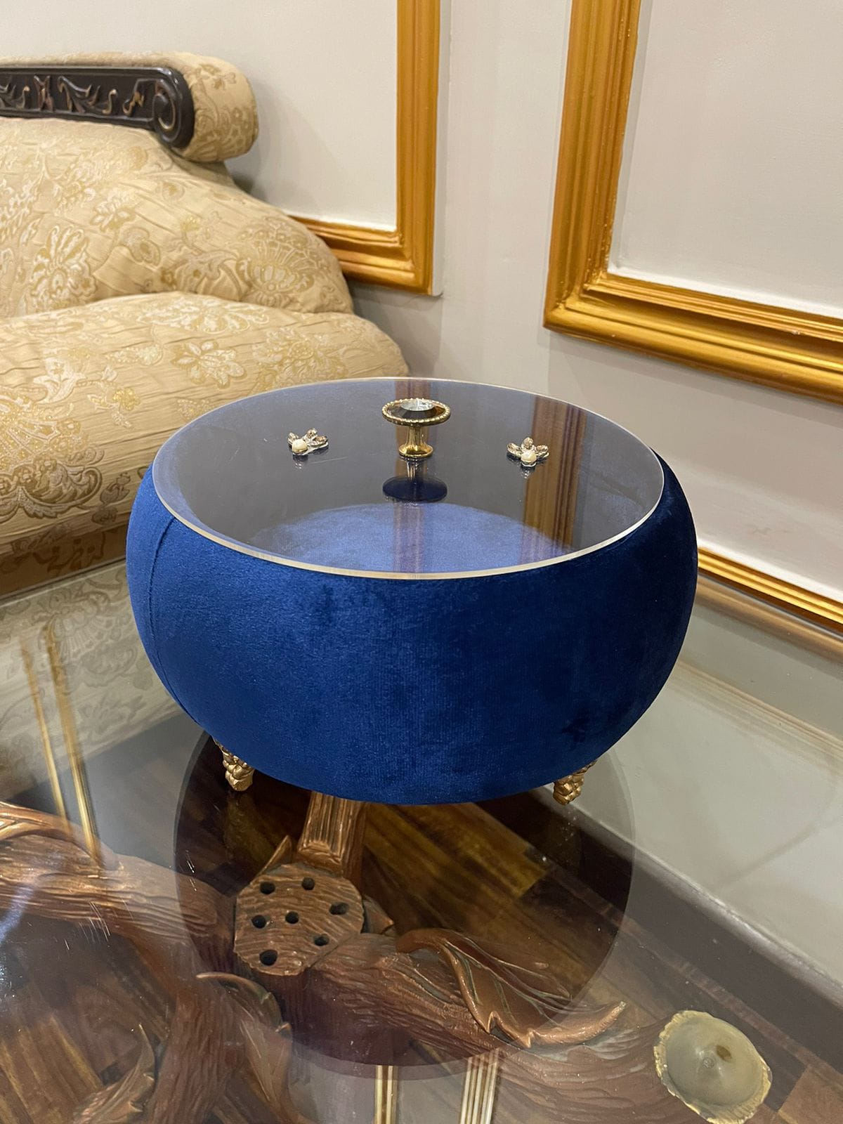 Blue round Turkish hotpoy with gold accents in a decorative room